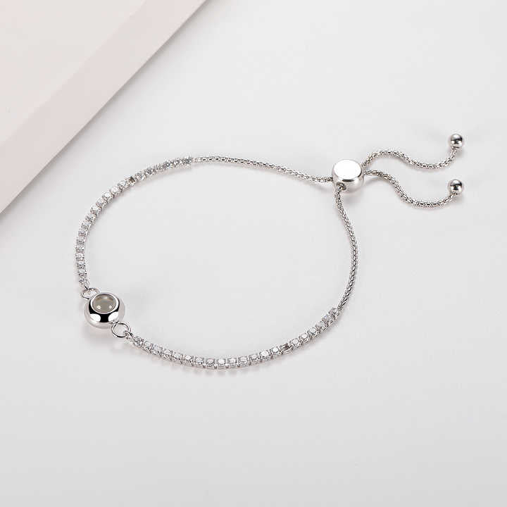 Delicate tennis bracelet with an encrypted pearl
